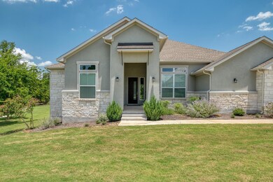 View of front of property with stone siding, stuc