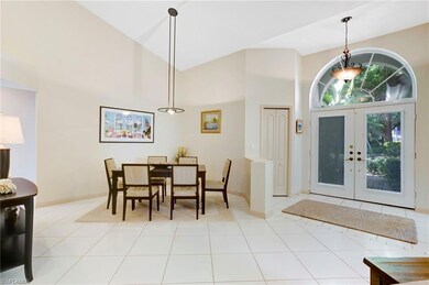 Dining space featuring an abundance of natural light, tile floors, and vaulted ceiling