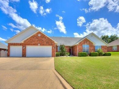 Traditional-style house featuring driveway, brick siding, a front lawn, and a garage