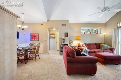 Carpeted living room with ceiling fan with notable