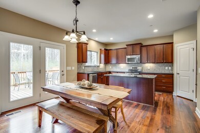 Lovely kitchen with island, stainless appliances, granite, bar seating area, plus eat-in area and walk-in pantry!