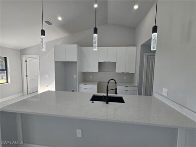 Kitchen featuring pendant lighting, white cabinetr