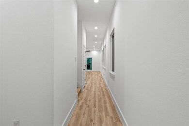Hallway with light hardwood / wood-style flooring