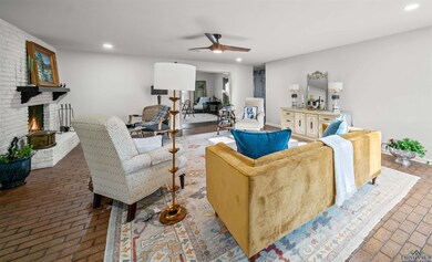 Living room featuring a fireplace, recessed lighti