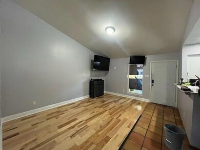 Unfurnished living room featuring baseboards