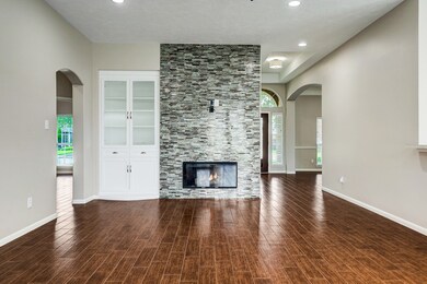 this gas log fireplace with modern glass tile accents is a captivating focal point that marries the comfort of tradition with the allure of contemporary design.