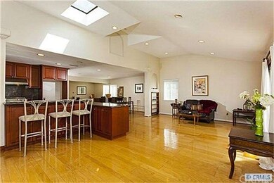Open Family Room with Skylight and Wood Flooring