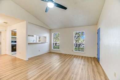 Empty room with ceiling fan, light wood finished 