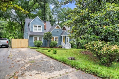 View of front of property with driveway and a shingled roof