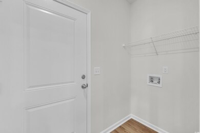 Washroom featuring laundry area, hookup for a wash