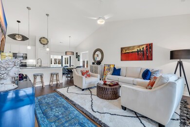 Living room with ceiling fan, dark hardwood / wood