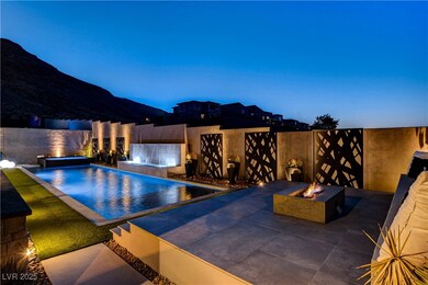 View of pool & spa with an outdoor fire pit and ra