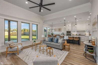 Living room featuring ornamental molding, light ha