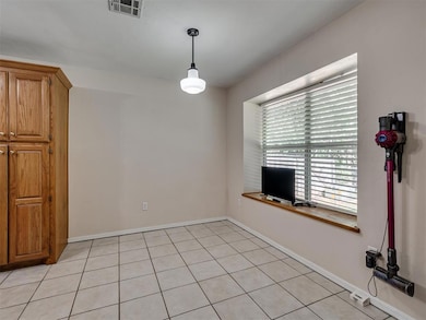 Unfurnished dining area with baseboards and light tile patterned floors