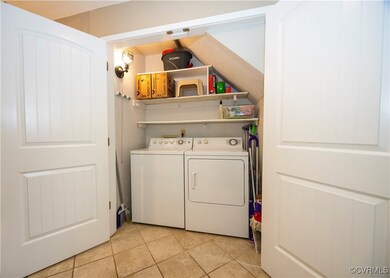 Laundry area with tile and storage shelfs