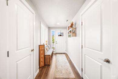 Entryway with wood finished floors and baseboards