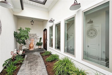Welcoming courtyard with wall of windows leads you
