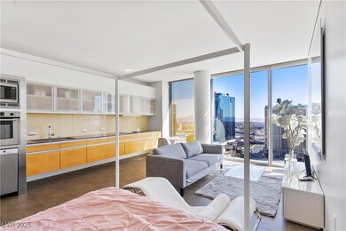 Living area featuring a city view, a wall of windo