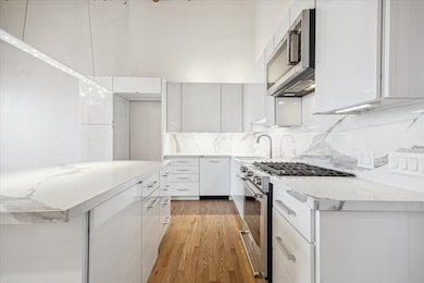 Sleek kitchen with smartly planned upper and lower storage. The spacious island offers additional prep space.