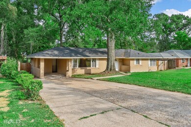Ranch-style home featuring a front yard and a carp