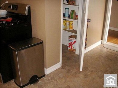 Pantry & faux tile flooring in kitchen.