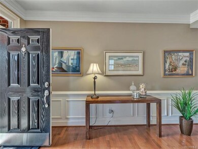Welcoming foyer with wainscoting detail, double cr