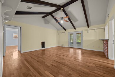 Living room with laminate flooring and vaulted ceilings