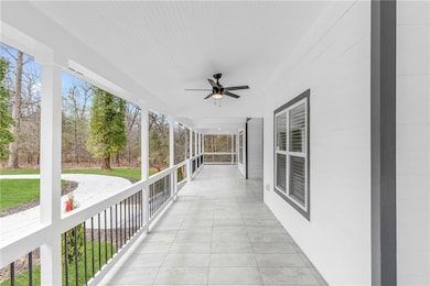 Covered porch featuring ceiling fan