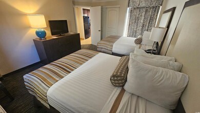 Bedroom featuring ornamental molding, black refrig