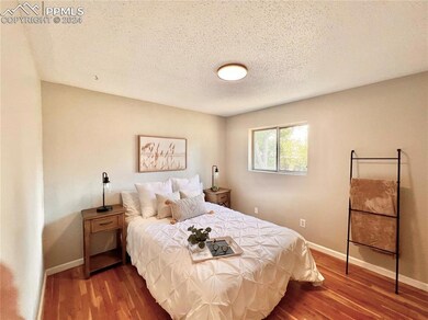 Bedroom with dark hardwood / wood-style floors and