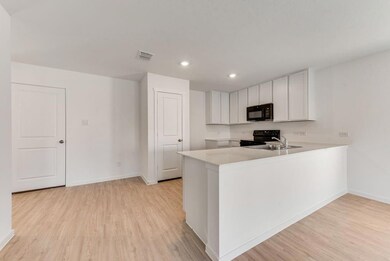 Kitchen featuring kitchen peninsula, white cabinet