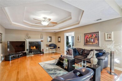 Large family room with ceiling fan, crown molding,