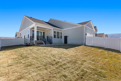 Back of house featuring a fenced backyard, a shingled roof, board and batten siding, and covered porch