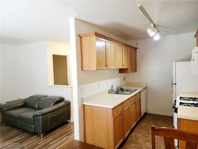 Kitchen with white appliances, track lighting