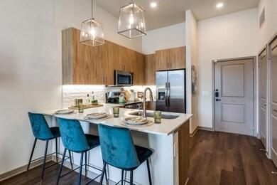 Kitchen with sink, a breakfast bar, stainless stee