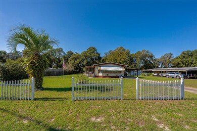 A welcoming view from the front emphasizes the home's charming exterior, mature landscaping, and wide-open front lawn.