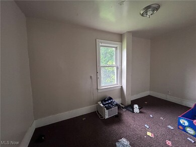 Unfurnished room featuring baseboards