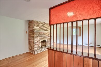 An open family room boasts neutral tones and gleaming hardwood floors.