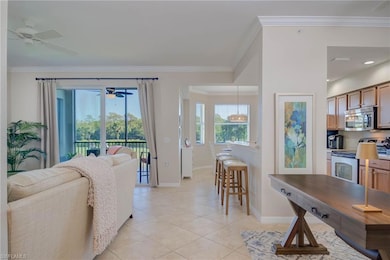 Living area featuring crown molding, a ceiling fan