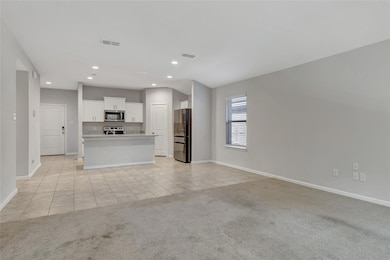 Unfurnished living room with light colored carpet