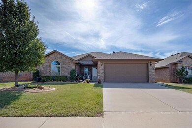 Ranch-style house with a garage and a front lawn