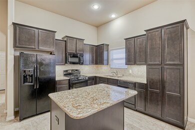 Loads of counter and cabinet space including a built-in pantry and a side-by-side refrigerator with water and ice dispenser.