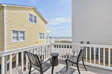 Deck with a beach view and a water view