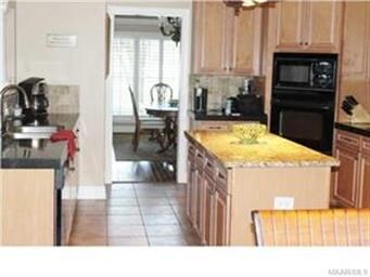 Kitchen Shown With Large Granite Island In Center 