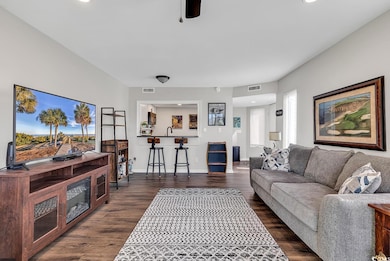 Living room with dark hardwood / wood-style floori