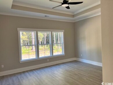 Unfurnished room with ornamental molding, a raised