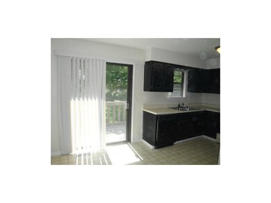 Eat-in kitchen.  Patio door leads to small deck an