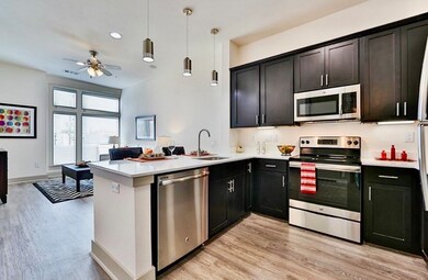 Stainless kitchen appliances and a dining/work isl