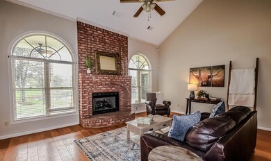 Living area featuring wood-type flooring, high vau
