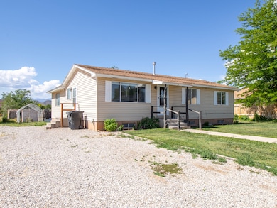 View of front of home featuring gravel driveway